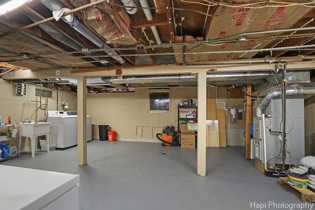 unfinished below grade area with washing machine and clothes dryer and heating unit