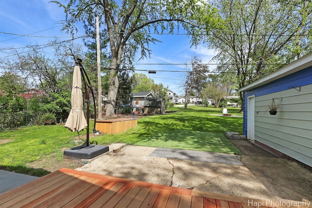 view of green lawn with a patio and an outbuilding