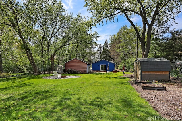 view of green lawn with a storage unit, an outdoor structure, and view of scattered trees