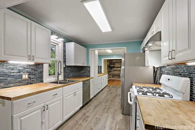 kitchen with wooden counters, white gas stove, a sink, under cabinet range hood, and ornamental molding