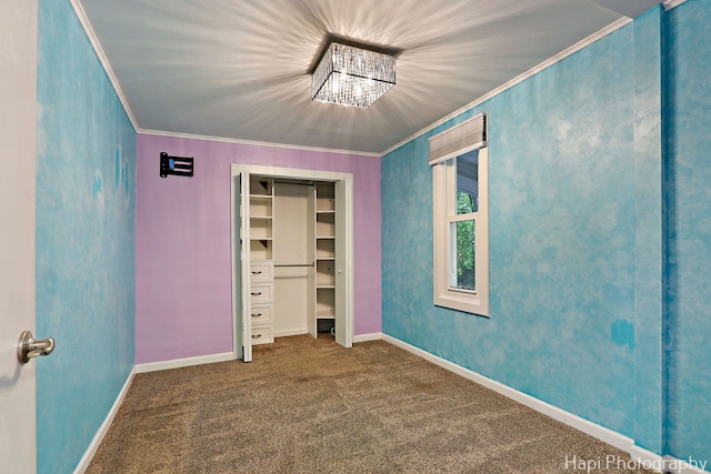 unfurnished bedroom with crown molding, carpet flooring, baseboards, and a closet