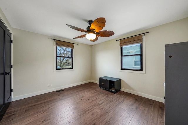 1324 Elmhurst Ln, Schaumburg, IL 60194 - spare room with healthy amount of natural light, baseboards, wood finished floors, and a ceiling fan