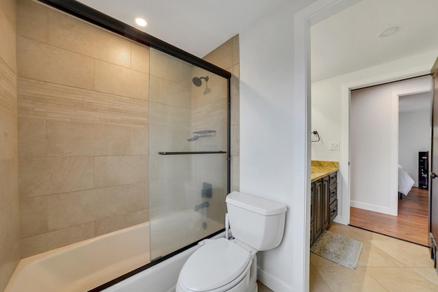 1324 Elmhurst Ln, Schaumburg, IL 60194 - full bath featuring tile patterned floors, toilet, bath / shower combo with glass door, baseboards, and vanity