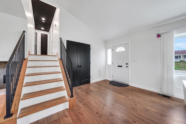 1324 Elmhurst Ln, Schaumburg, IL 60194 - entrance foyer featuring wood finished floors, stairway, vaulted ceiling, and baseboards