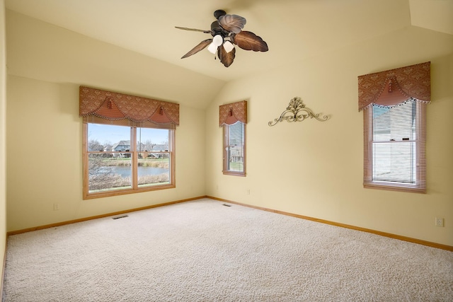 carpeted spare room with baseboards, ceiling fan, and lofted ceiling