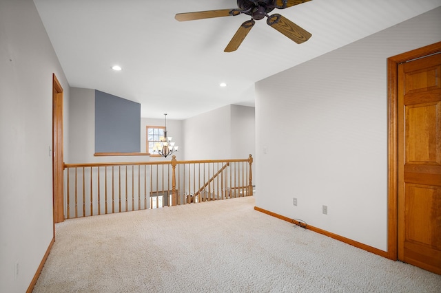 spare room with a chandelier, carpet flooring, ceiling fan, baseboards, and recessed lighting