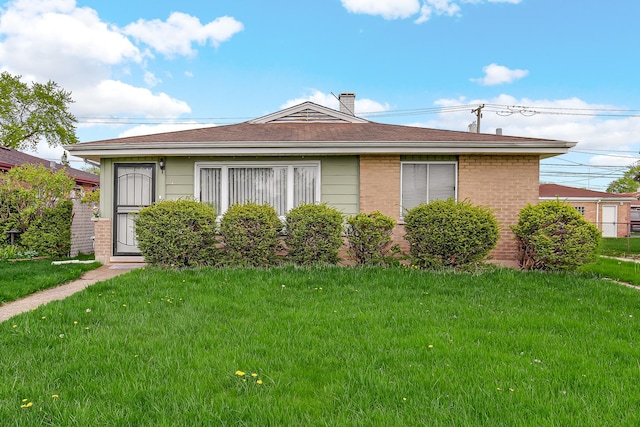 1383 Greenbay Ave, Calumet City, IL 60409 - view of front of home with brick siding, a front lawn, and a chimney