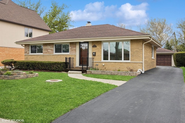 view of front of house featuring brick siding, a front yard, a garage, a chimney, and roof with shingles