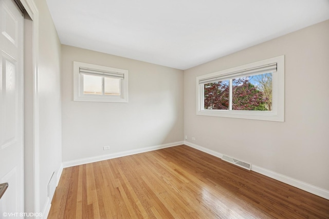 spare room with light wood-style flooring and baseboards