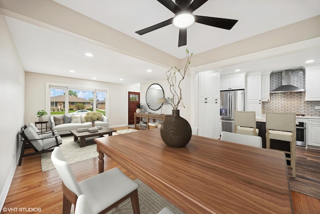 dining room featuring baseboards, light wood-style flooring, ceiling fan, and recessed lighting