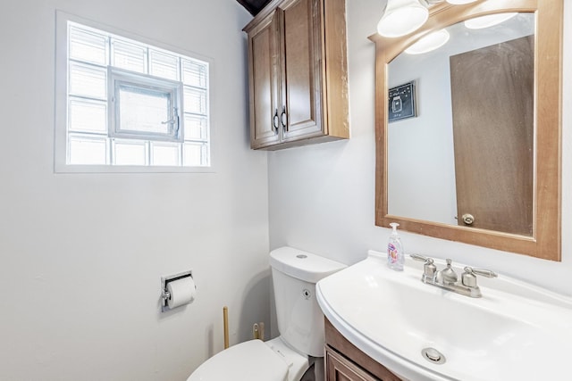 bathroom featuring toilet and vanity