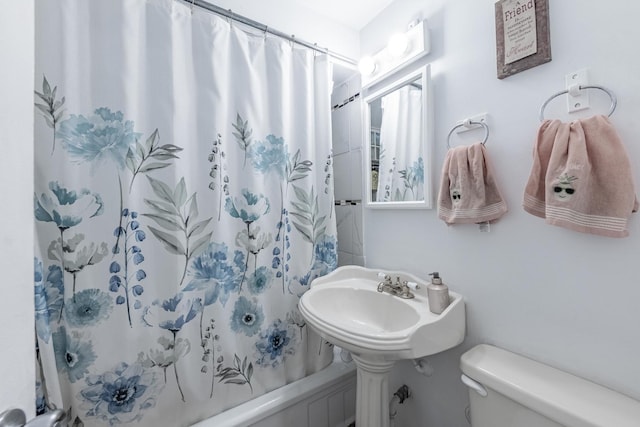 full bath featuring toilet and shower / tub combo with curtain