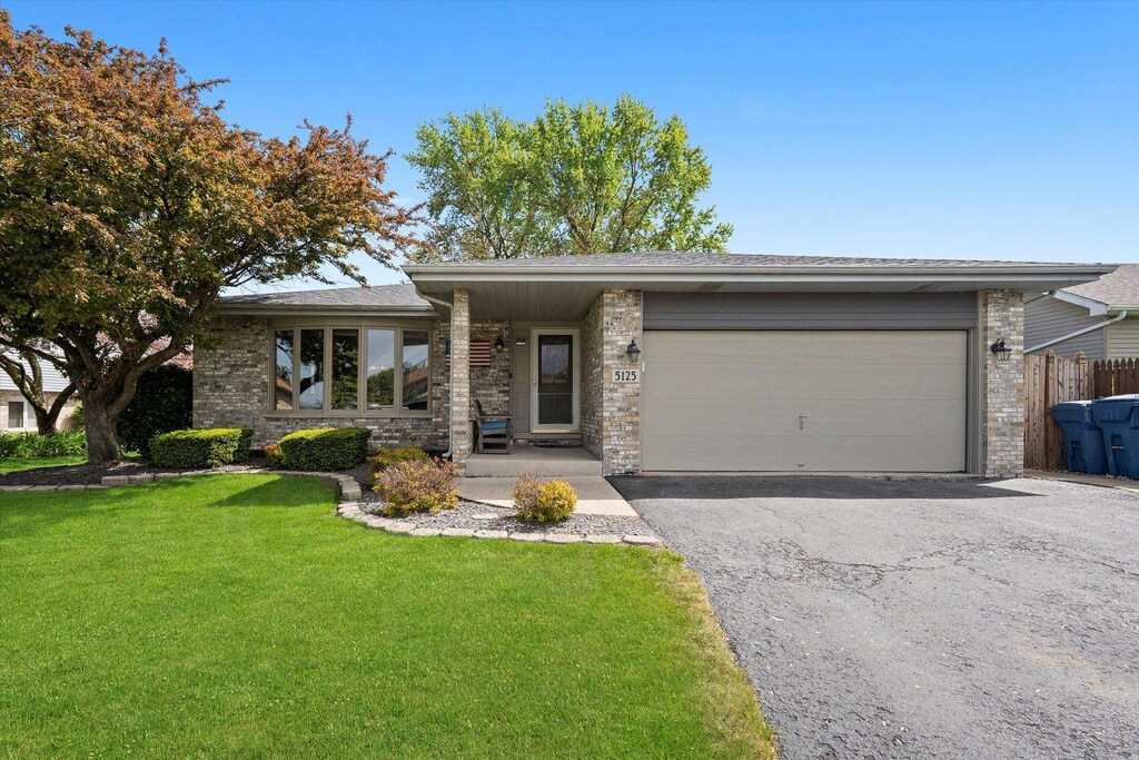 5125 148th Ct, Midlothian, IL 60445 - view of front facade featuring an attached garage, asphalt driveway, brick siding, and roof with shingles