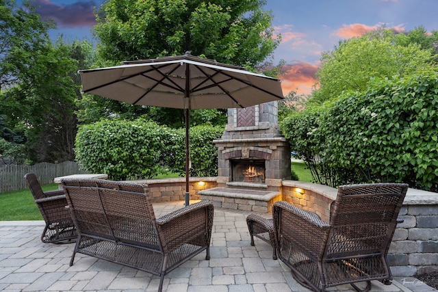 13362 S Golden Meadow Dr, Plainfield, IL 60585 - patio terrace at dusk with an outdoor stone fireplace and a patio