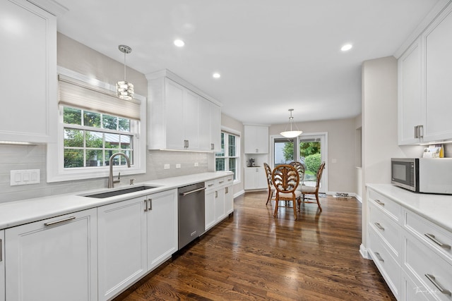 13362 S Golden Meadow Dr, Plainfield, IL 60585 - kitchen with stainless steel appliances, a sink, white cabinets, decorative backsplash, and light countertops