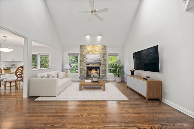 13362 S Golden Meadow Dr, Plainfield, IL 60585 - living room with high vaulted ceiling, a stone fireplace, a ceiling fan, and dark wood-type flooring