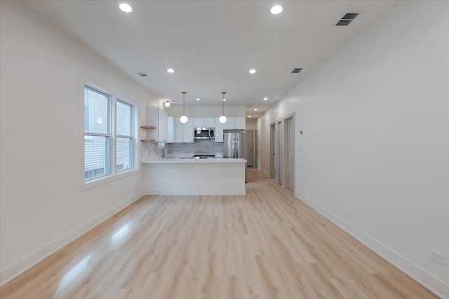 1808 N Karlov Ave, Chicago, IL 60639 - unfurnished living room with light wood-style floors, recessed lighting, baseboards, and a sink