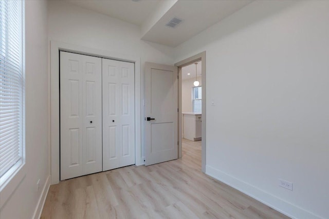 1808 N Karlov Ave, Chicago, IL 60639 - unfurnished bedroom featuring light wood-style floors, baseboards, and a closet