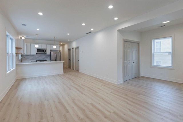 1808 N Karlov Ave, Chicago, IL 60639 - kitchen with a sink, light wood-style flooring, stainless steel dishwasher, plenty of natural light, and recessed lighting