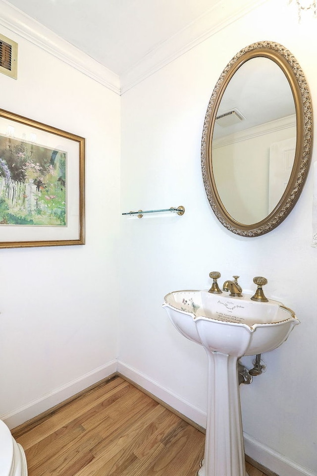 1054 Evergreen Dr, Carol Stream, IL 60188 - bathroom with crown molding, wood finished floors, baseboards, and toilet