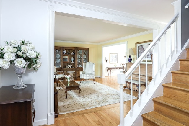 1054 Evergreen Dr, Carol Stream, IL 60188 - living area featuring wood finished floors, stairs, and ornamental molding