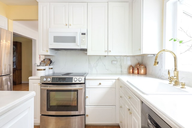 1054 Evergreen Dr, Carol Stream, IL 60188 - kitchen featuring stainless steel appliances, a sink, white cabinets, and backsplash