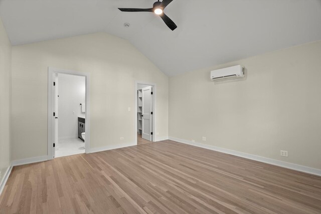 250 N Oak St, Palatine, IL 60067 - unfurnished bedroom with a wall mounted air conditioner, lofted ceiling, light wood-type flooring, and baseboards