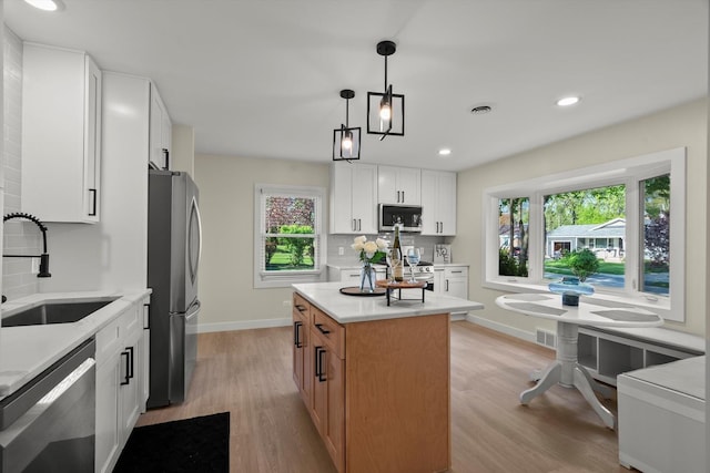 250 N Oak St, Palatine, IL 60067 - kitchen with appliances with stainless steel finishes, a sink, light countertops, light wood-type flooring, and recessed lighting