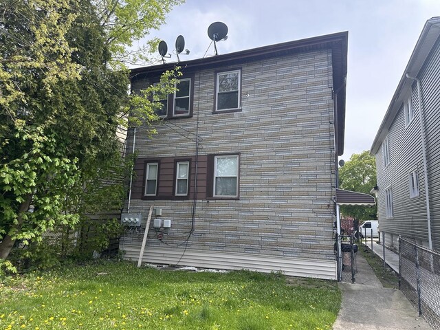 view of property exterior with a lawn