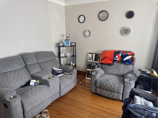 living room with ornamental molding and wood finished floors