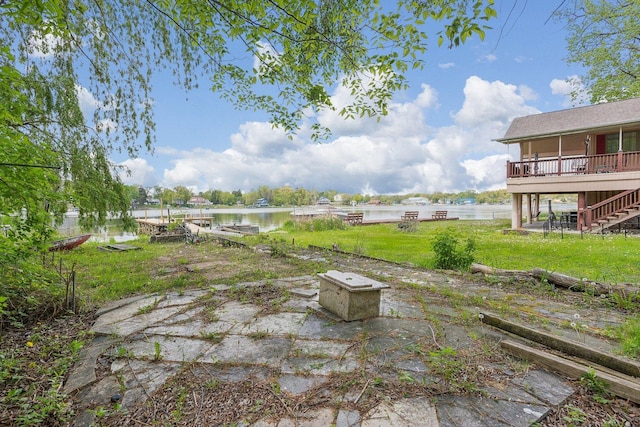 26211 W Spring Grove Rd, Antioch, IL 60002 - view of green lawn with stairway, a deck with water view, and a patio area