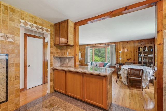 26211 W Spring Grove Rd, Antioch, IL 60002 - kitchen with brown cabinets, a peninsula, light stone countertops, and open floor plan