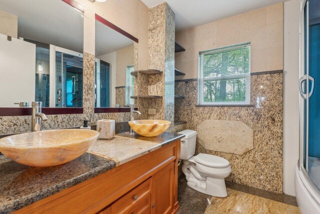 26211 W Spring Grove Rd, Antioch, IL 60002 - bathroom with double vanity, tile walls, toilet, a shower, and tasteful backsplash