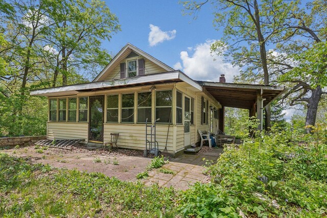 26211 W Spring Grove Rd, Antioch, IL 60002 - view of front of property with a chimney and a sunroom