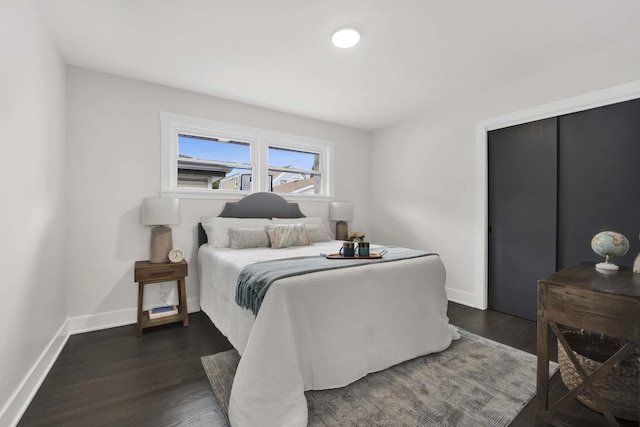 bedroom featuring wood finished floors and baseboards