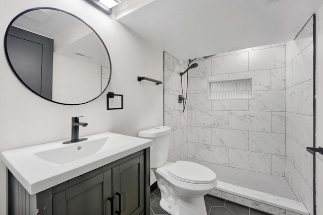full bath featuring vanity, toilet, a stall shower, and tile patterned floors