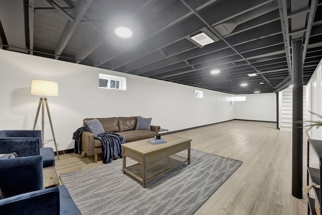 living area with wood finished floors and baseboards