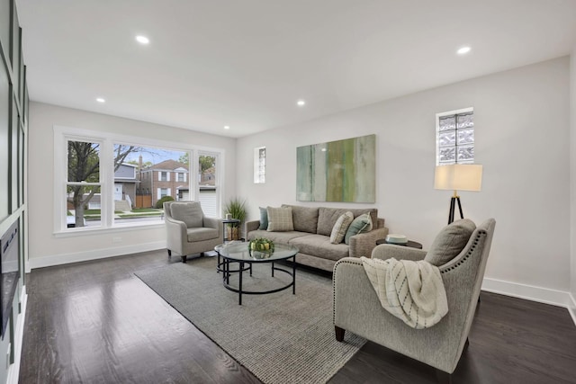 living room featuring baseboards, recessed lighting, and dark wood finished floors