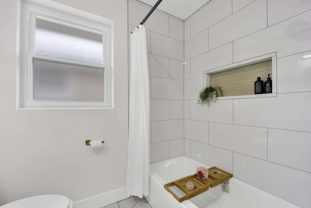 full bath with baseboards, toilet, shower / bath combo with shower curtain, and tile patterned floors