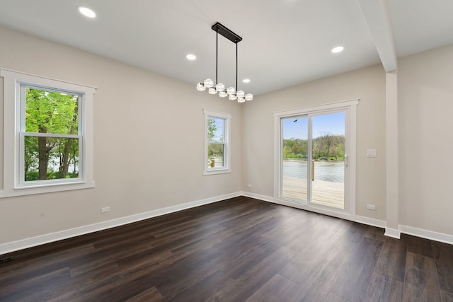 unfurnished room with dark wood finished floors, baseboards, and recessed lighting