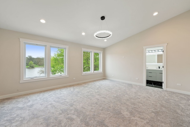 carpeted spare room featuring lofted ceiling, baseboards, and recessed lighting