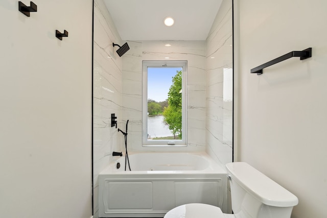 bathroom featuring a tub, toilet, and recessed lighting