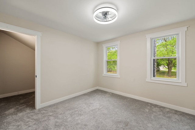 carpeted empty room with baseboards