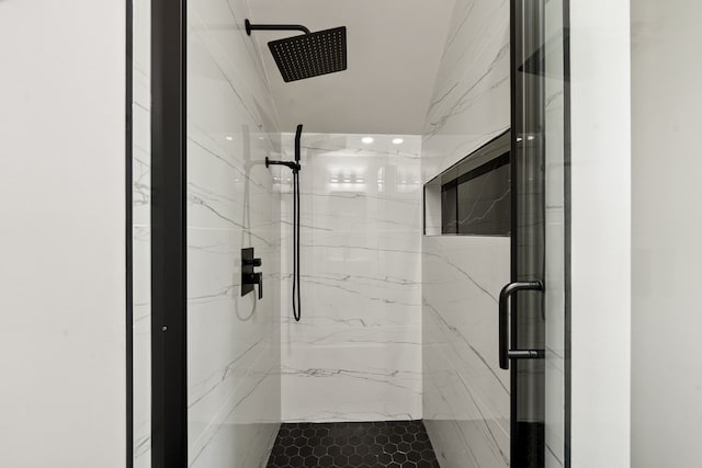 full bathroom with a marble finish shower