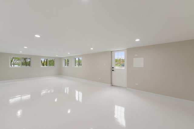 empty room featuring recessed lighting, healthy amount of natural light, baseboards, and light tile patterned flooring