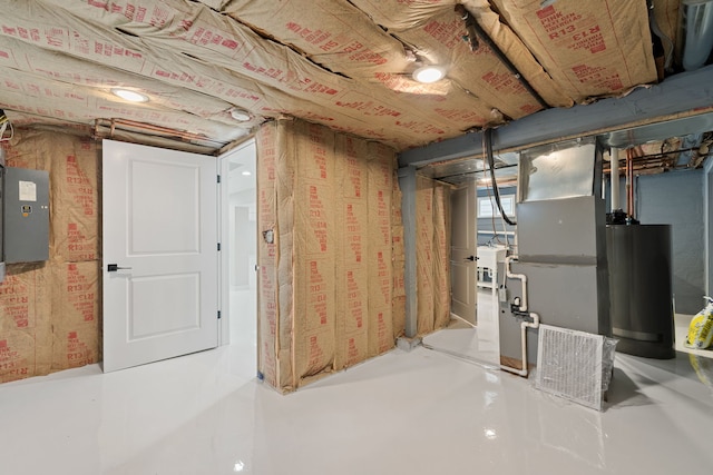 unfinished basement featuring gas water heater and heating unit