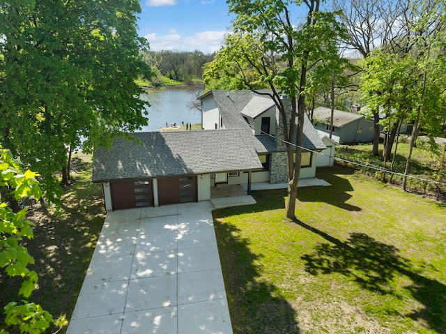 aerial view of property and surrounding area with a nearby body of water