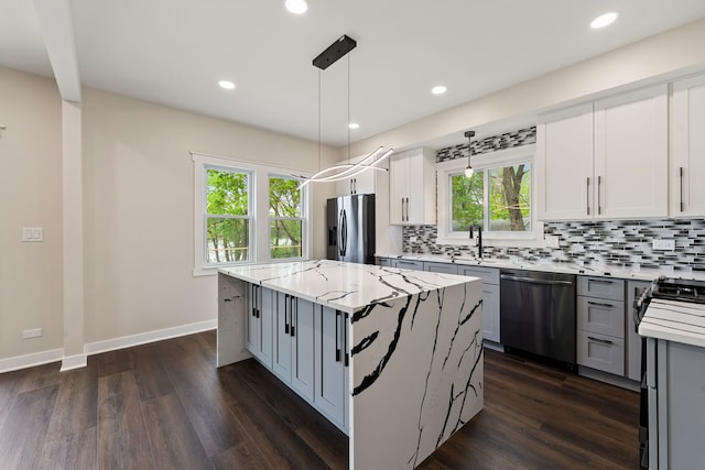 kitchen featuring stainless steel appliances, tasteful backsplash, a kitchen island, plenty of natural light, and recessed lighting