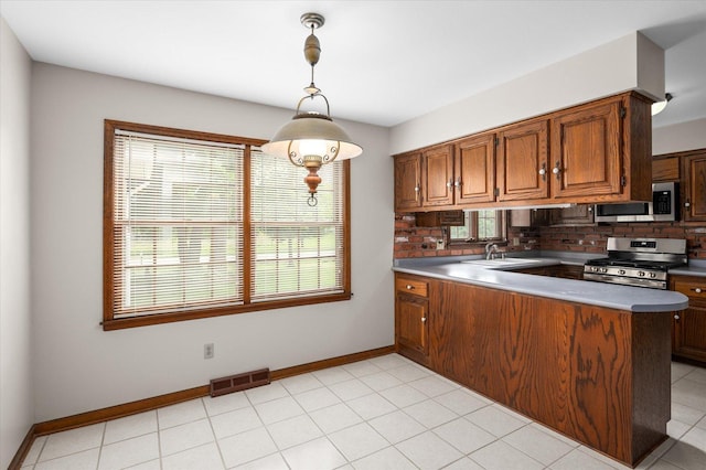 22 Cedar Gate Cir, Sugar Grove, IL 60554 - kitchen featuring stainless steel appliances, plenty of natural light, backsplash, and brown cabinetry