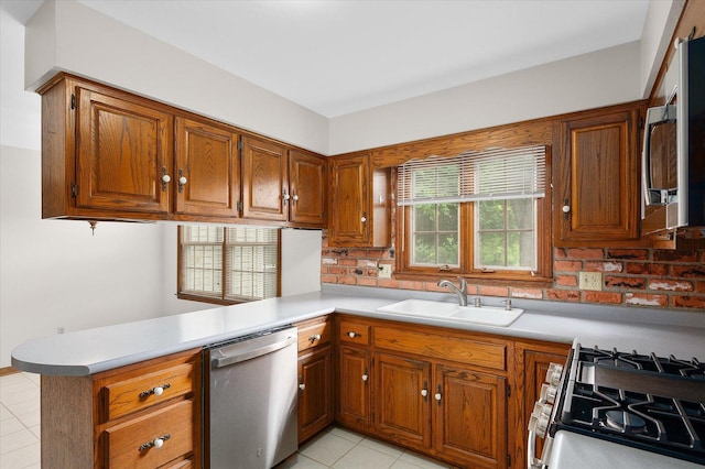 22 Cedar Gate Cir, Sugar Grove, IL 60554 - kitchen with stainless steel appliances, a sink, brown cabinetry, and light tile patterned floors